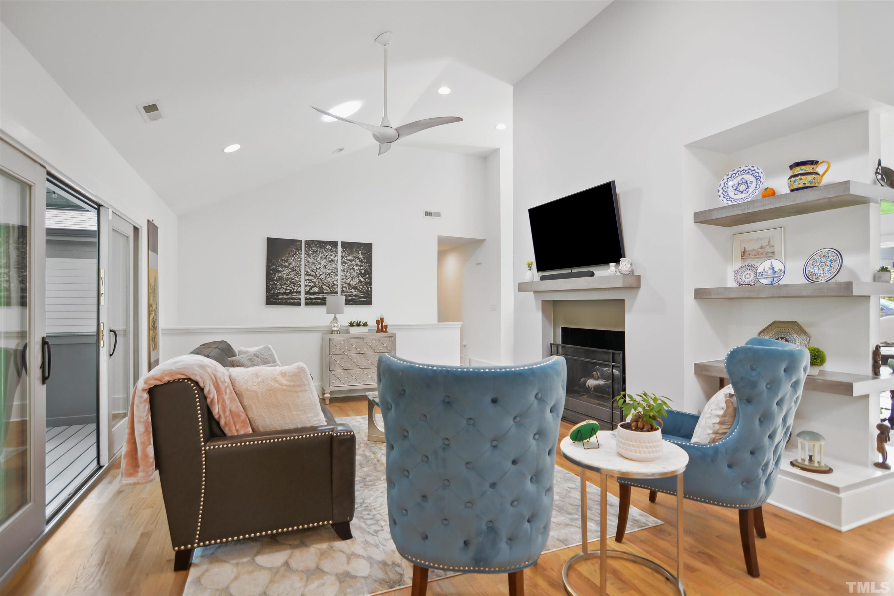 3210 Hampton Road Raleigh, NC 27607 - Photo 6 of 34 a living room with furniture a fireplace and a flat screen tv