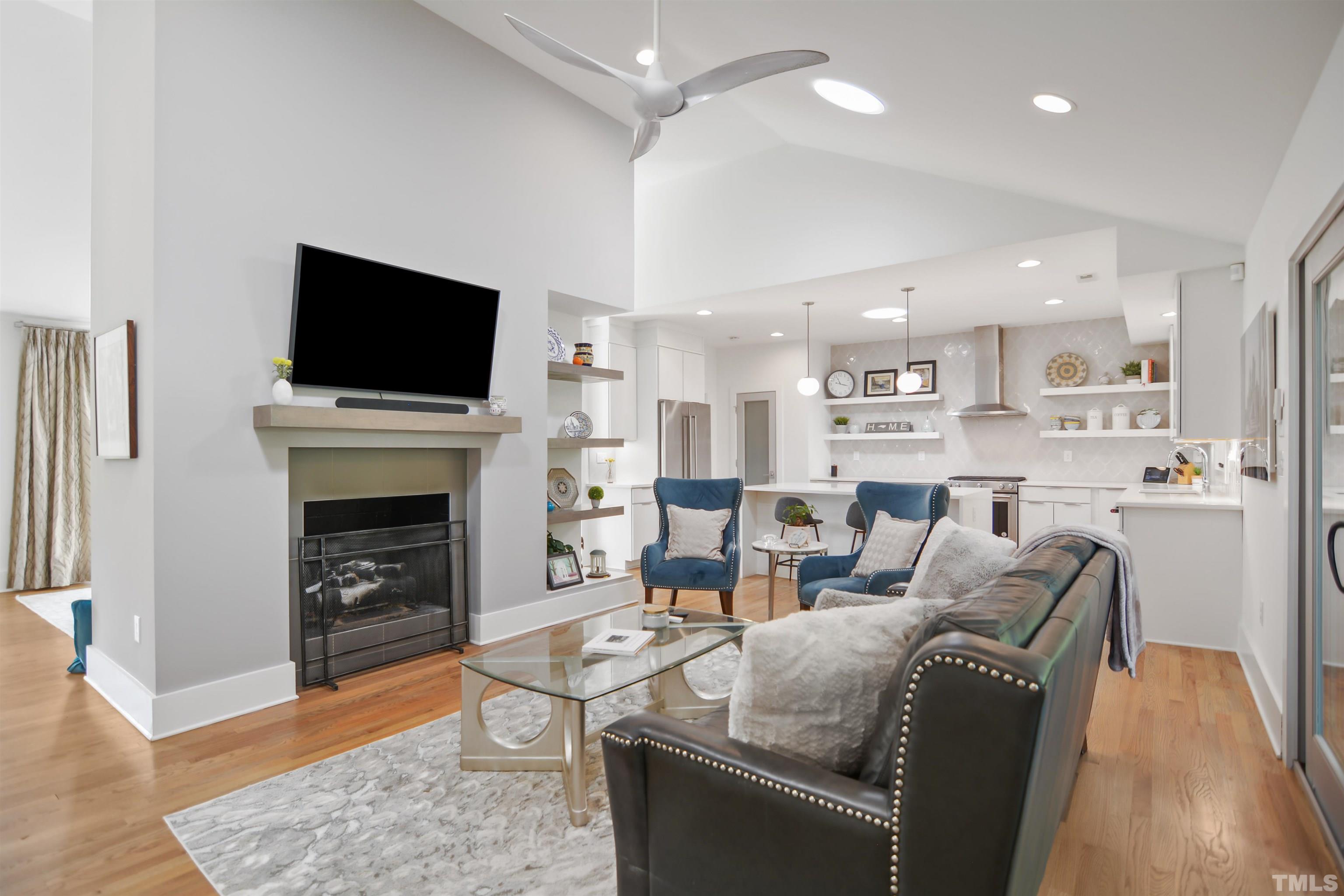 3210 Hampton Road Raleigh, NC 27607 - Photo 7 of 34 a living room with fireplace furniture and a flat screen tv