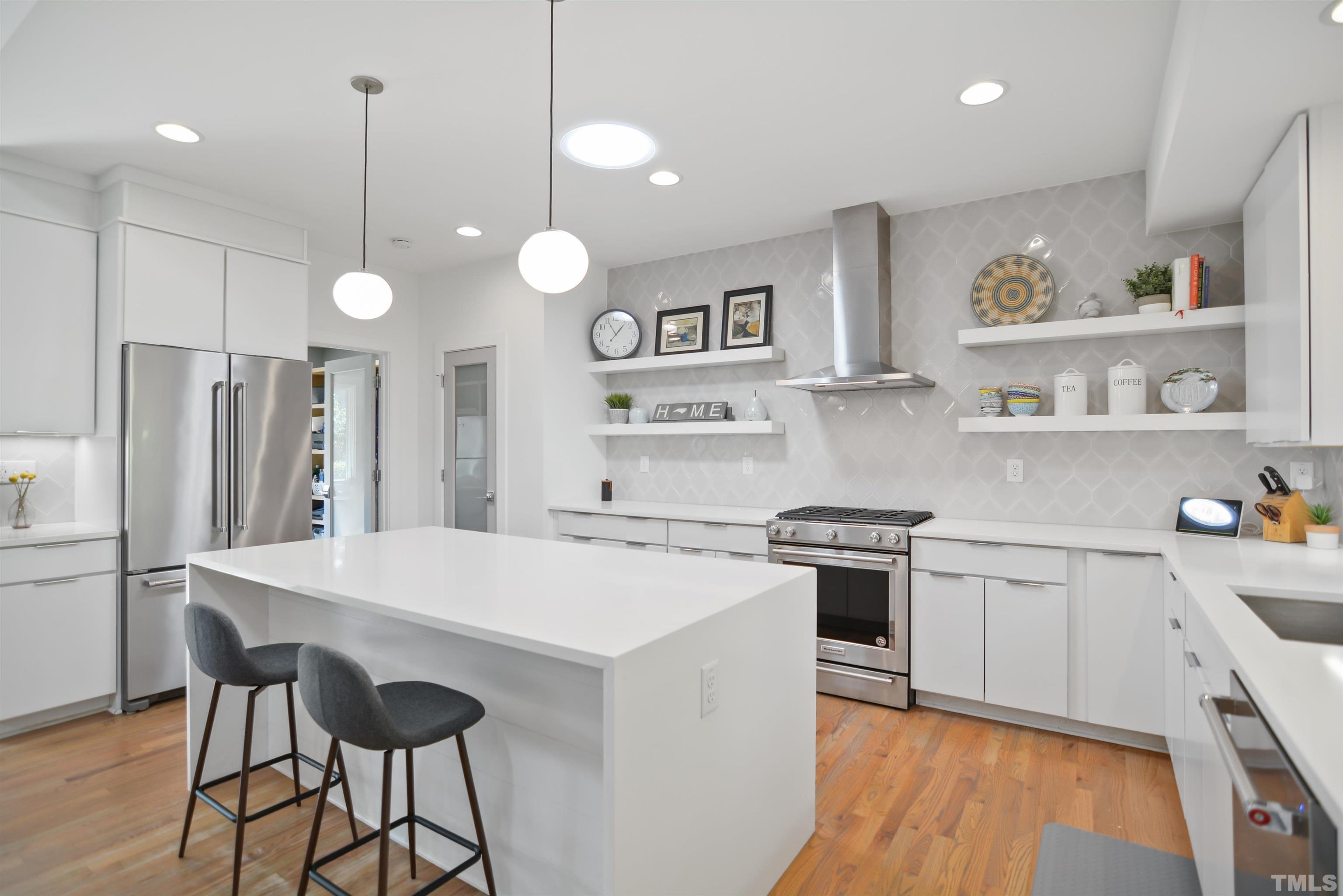 3210 Hampton Road Raleigh, NC 27607 - Photo 10 of 34 a kitchen with stainless steel appliances granite countertop a stove a sink refrigerator and a refrigerator