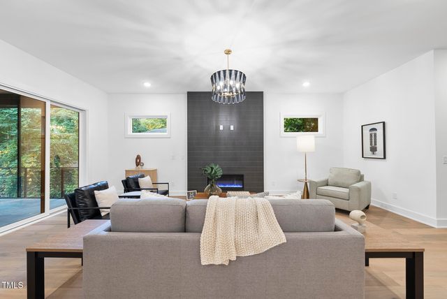 a living room with furniture and a chandelier