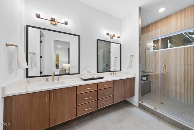 a bathroom with a double vanity sink mirror and double