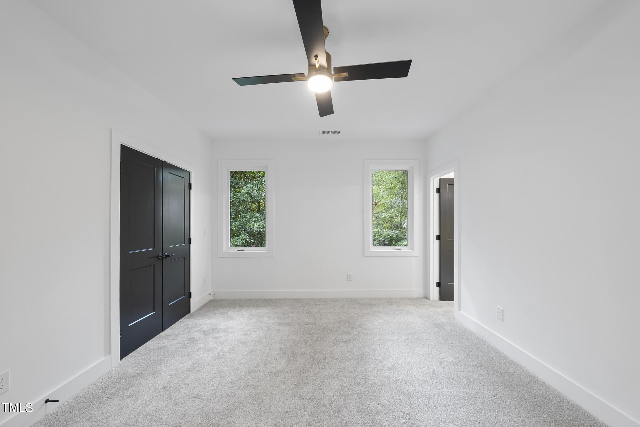 2603 Mayview Road Raleigh, NC 27607 - Photo 20 of 44 an empty room with windows and fan