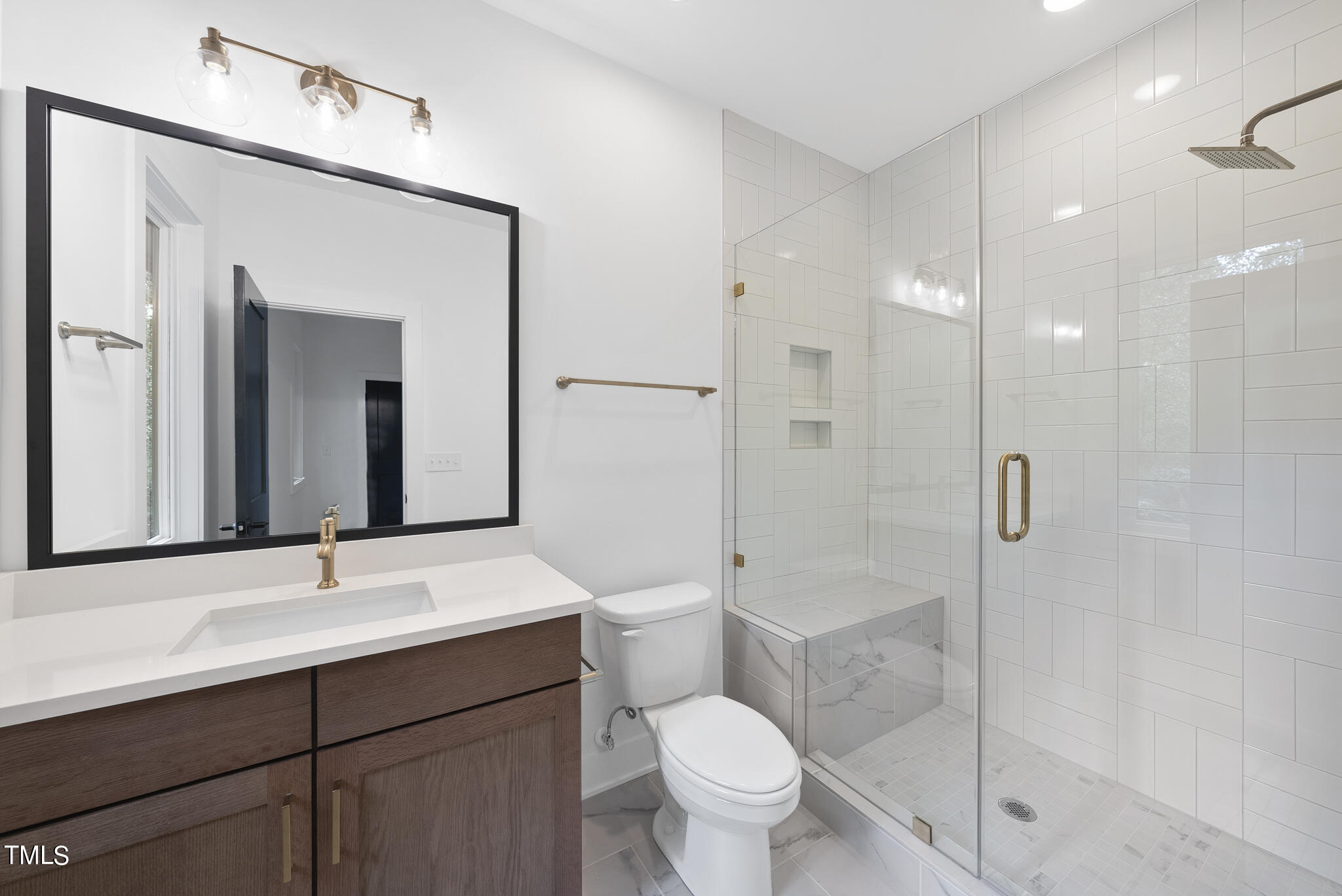 2603 Mayview Road Raleigh, NC 27607 - Photo 21 of 44 a bathroom with a sink a toilet and shower