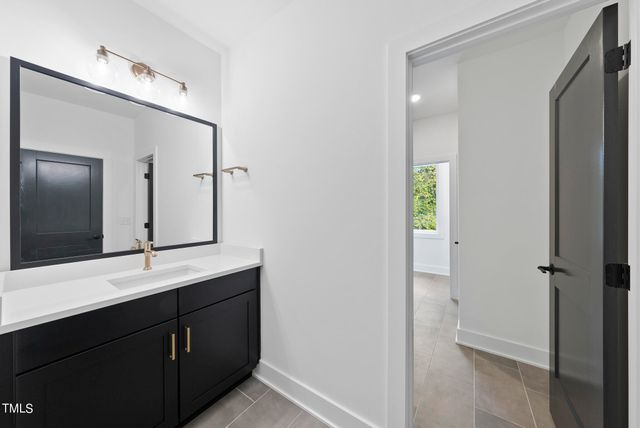 a bathroom with a double vanity sink and mirror