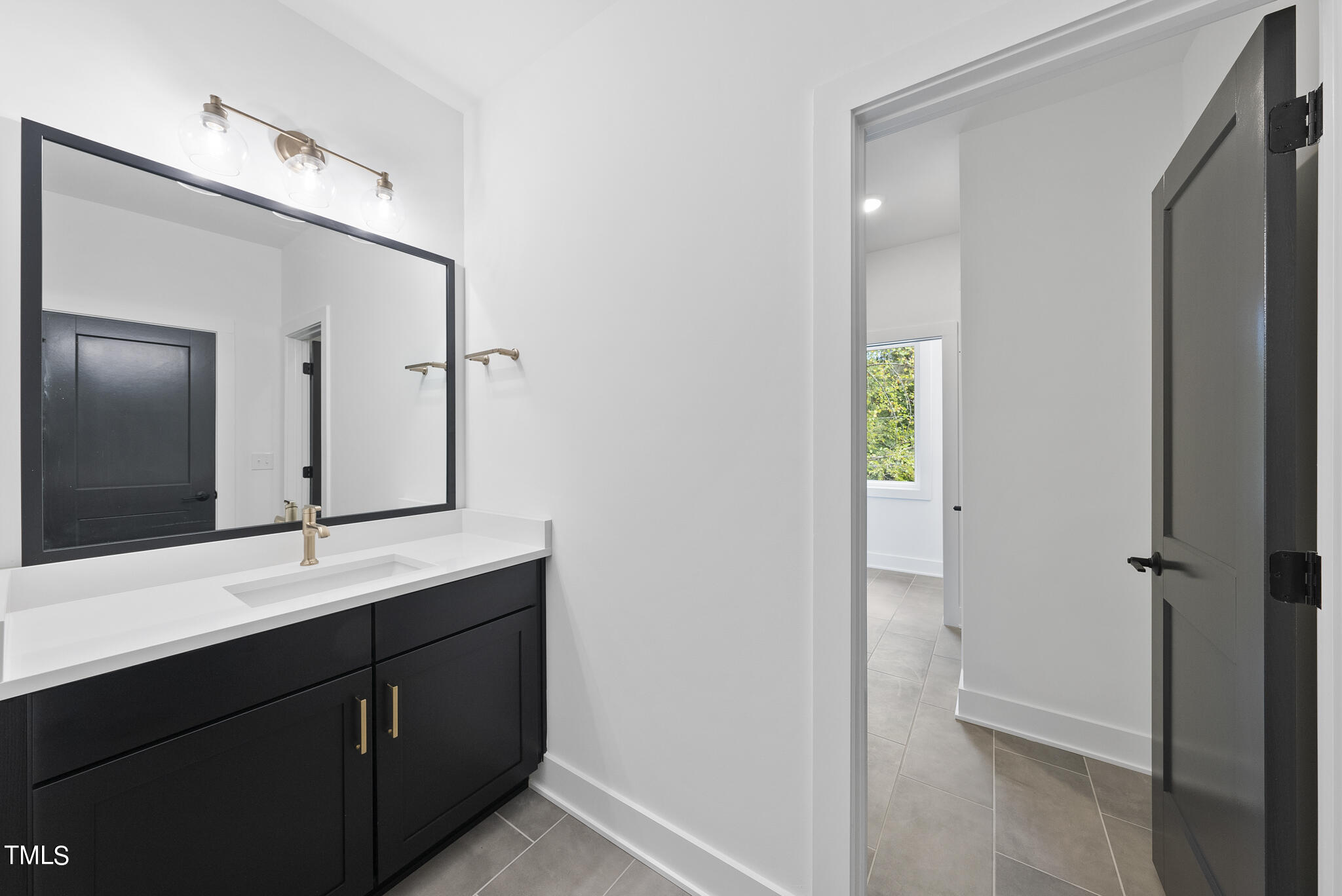 2603 Mayview Road Raleigh, NC 27607 - Photo 25 of 44 a bathroom with a double vanity sink and mirror
