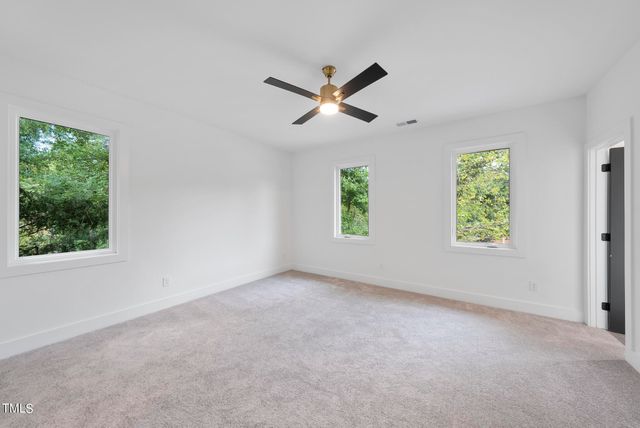 an empty room with windows and closet