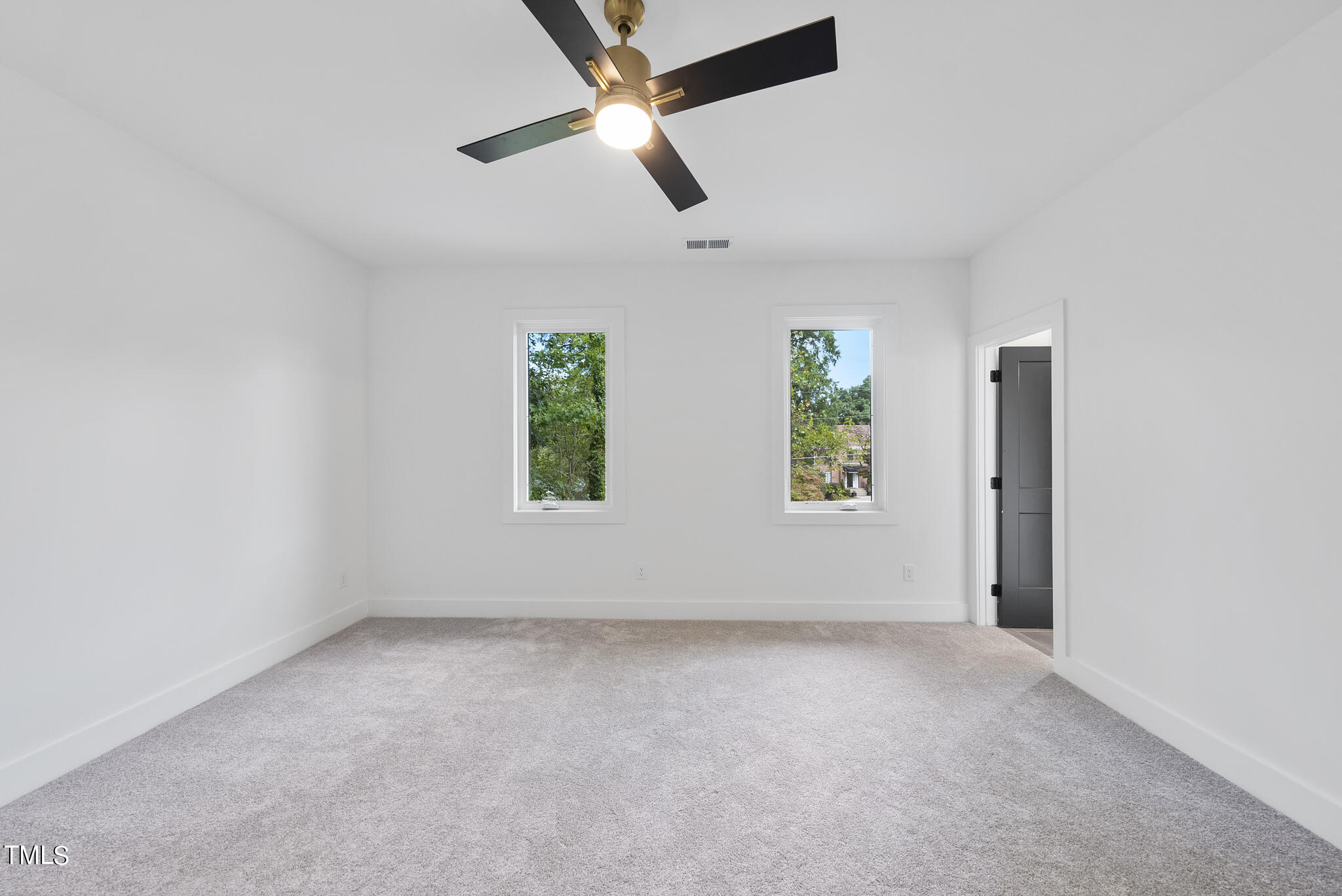 2603 Mayview Road Raleigh, NC 27607 - Photo 28 of 44 an empty room with windows and ceiling fan