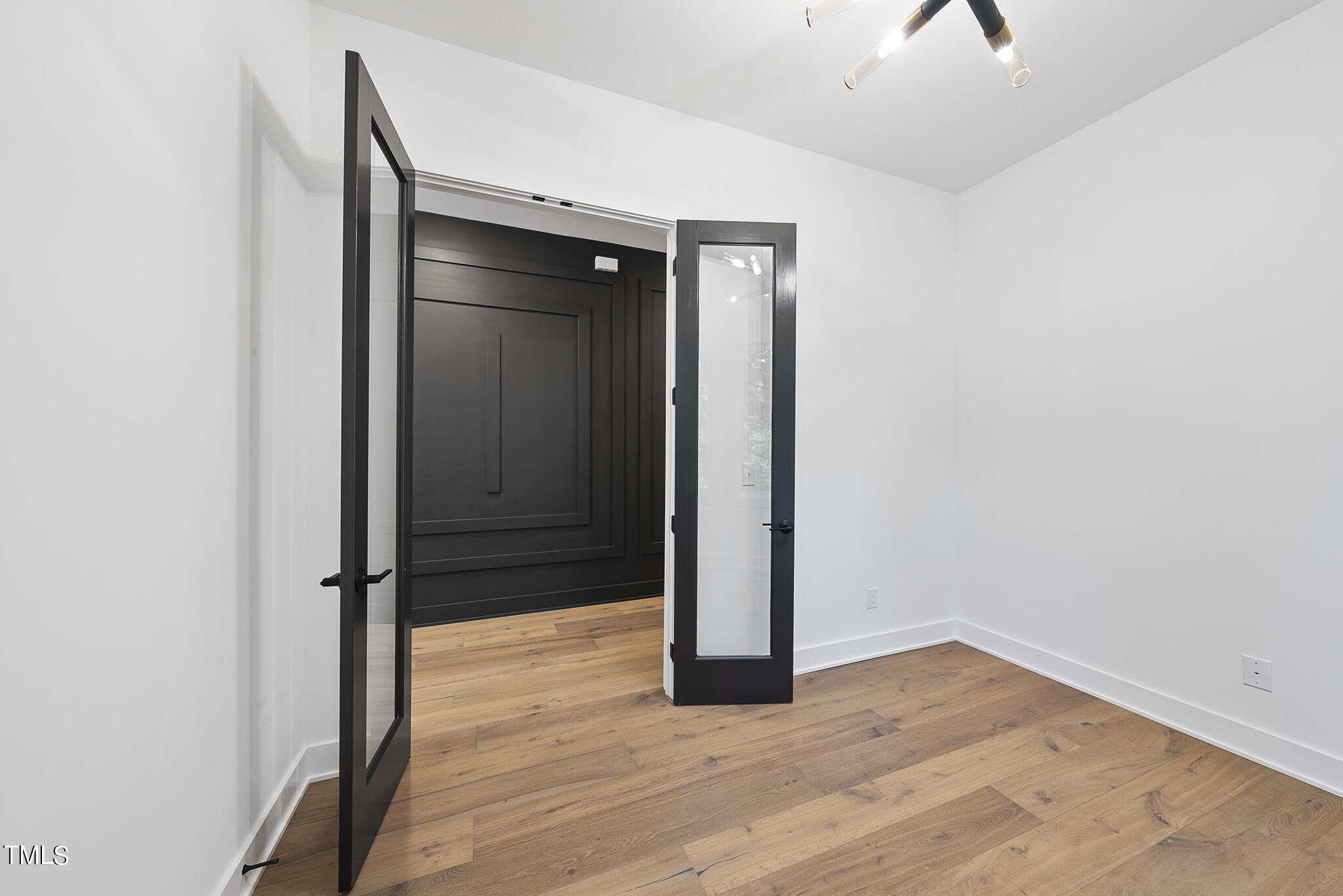 2603 Mayview Road Raleigh, NC 27607 - Photo 31 of 44 an empty room with wooden floor and bathroom