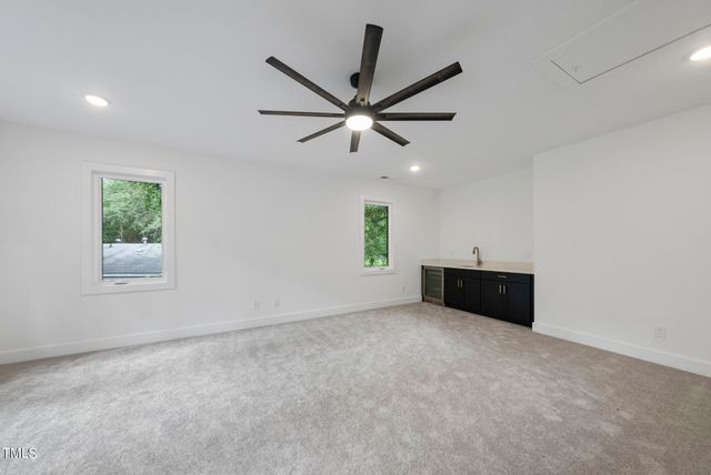 a view of a room with window and ceiling fan