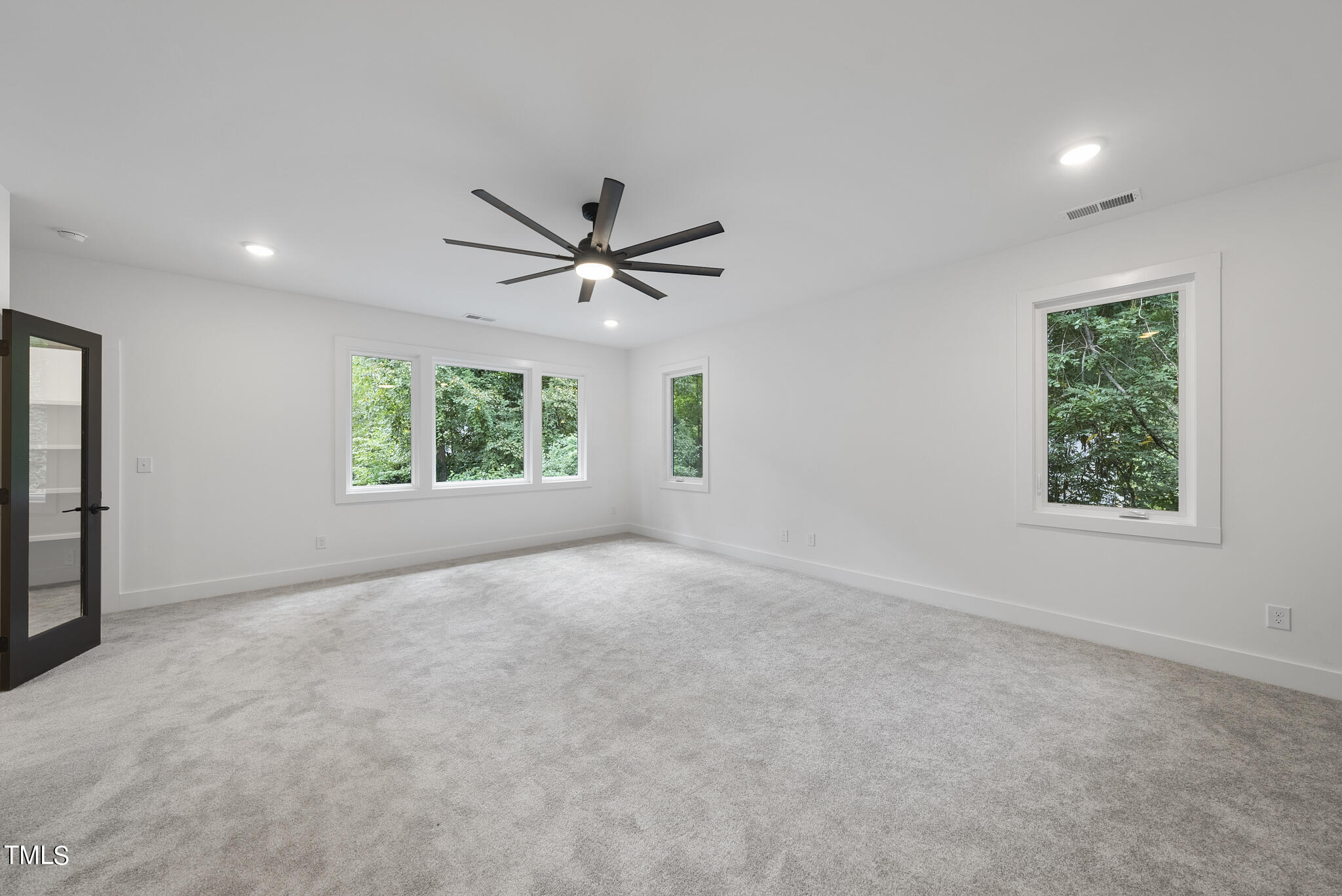 2603 Mayview Road Raleigh, NC 27607 - Photo 34 of 44 an empty room with windows and ceiling fan