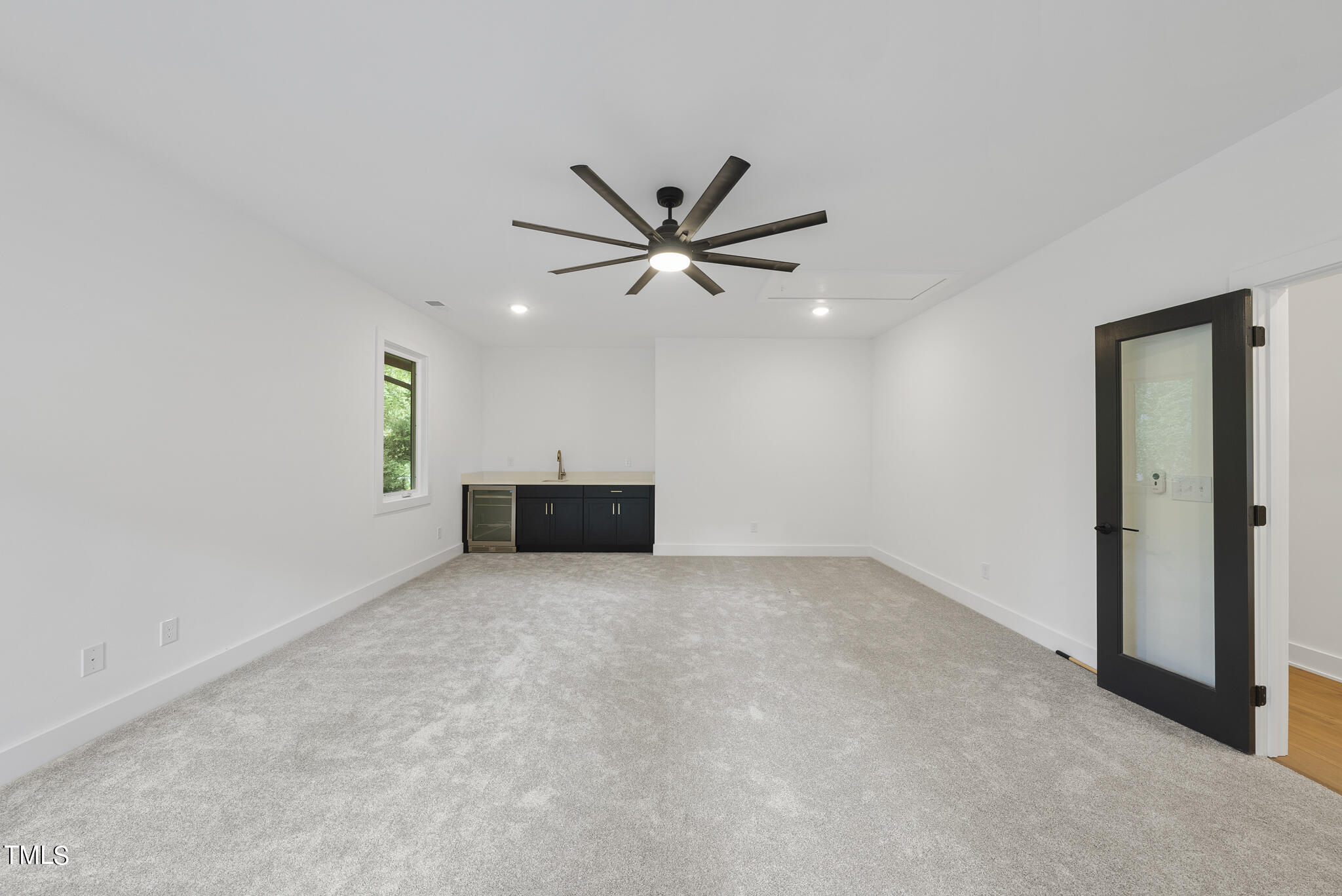 2603 Mayview Road Raleigh, NC 27607 - Photo 35 of 44 an empty room with chandelier fan and windows