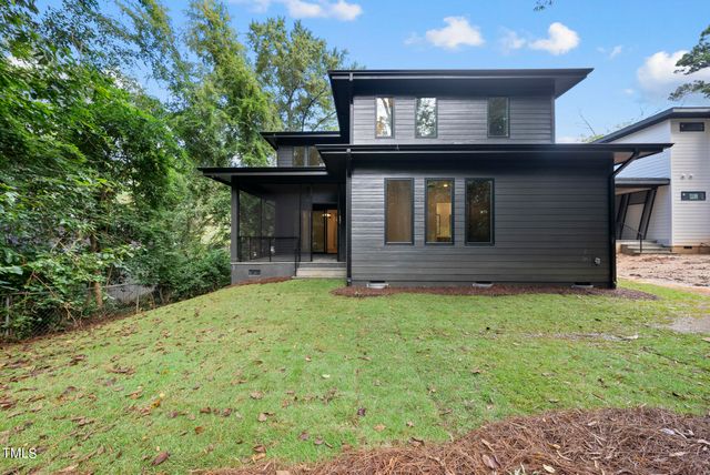 a house with lots of trees in the background