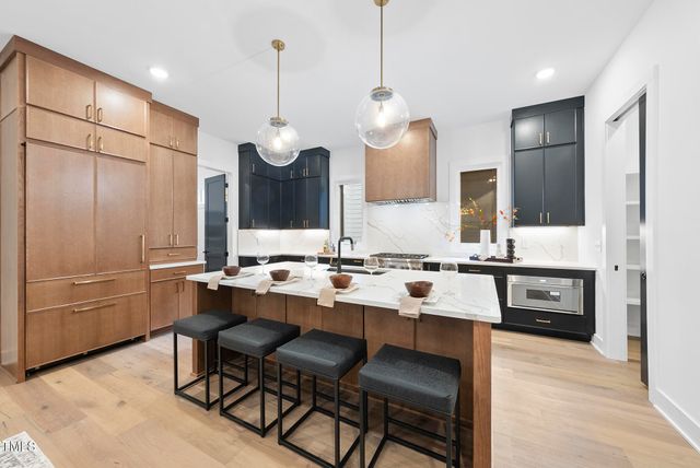 a kitchen with a sink refrigerator and cabinets