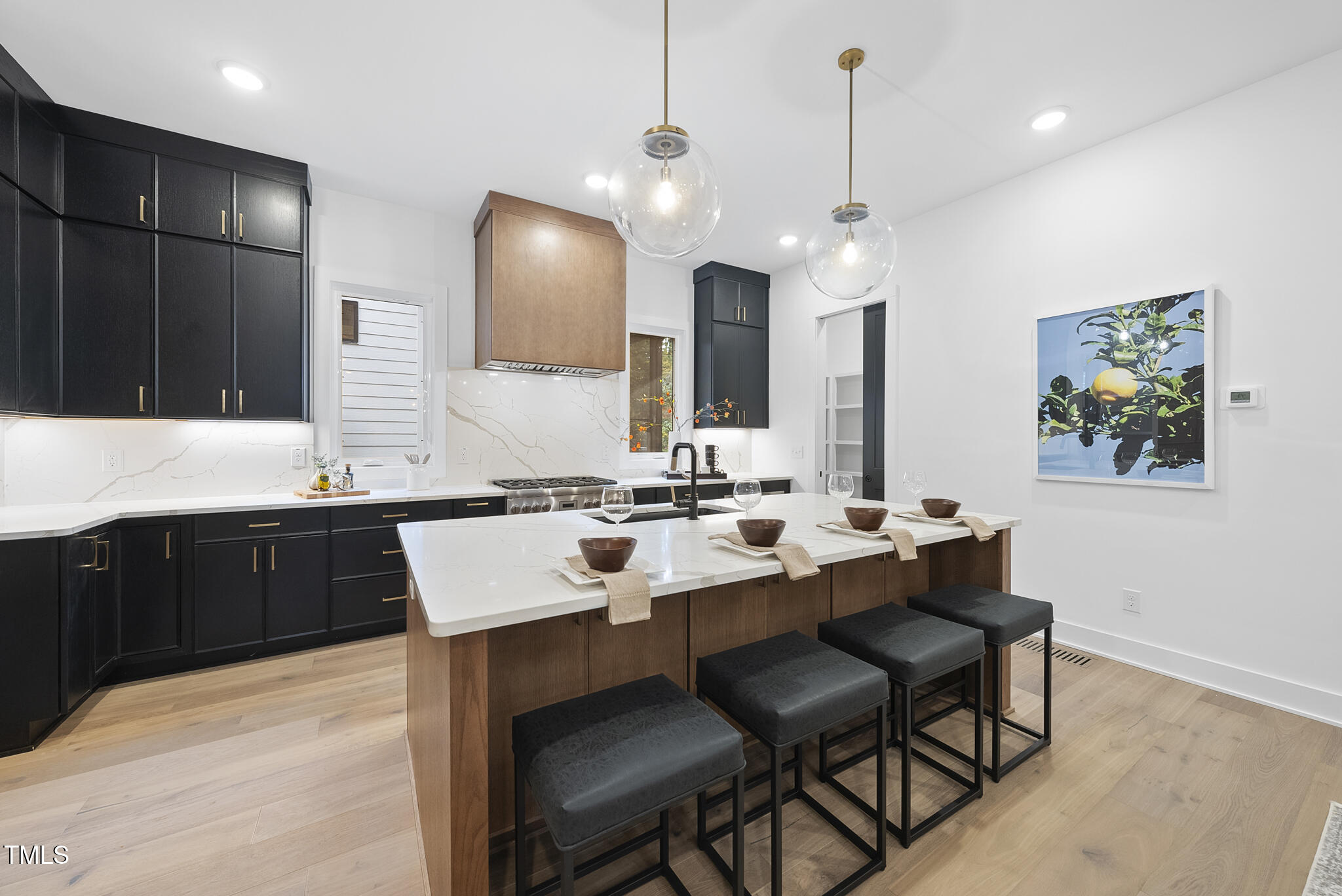 2603 Mayview Road Raleigh, NC 27607 - Photo 5 of 44 a large kitchen with a sink a counter space and chairs