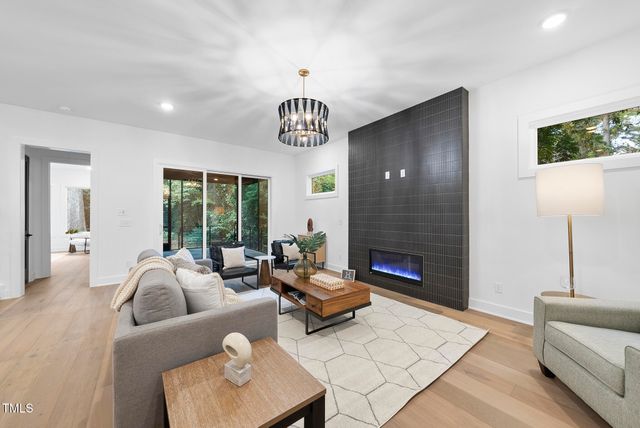 a living room with furniture fireplace and window