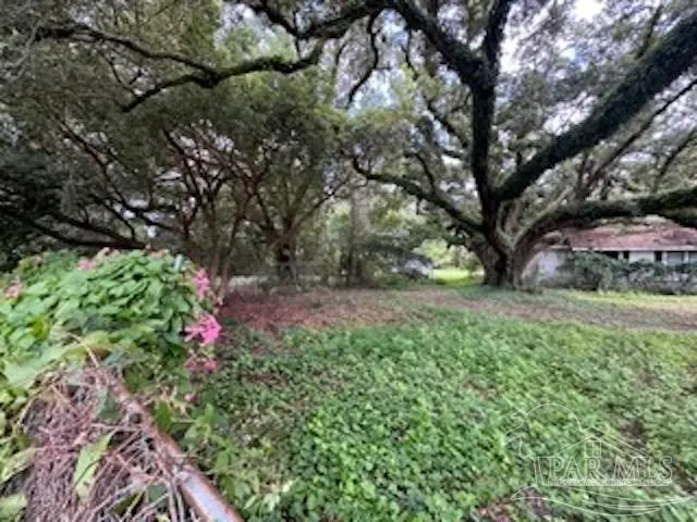 a view of a house with yard and sitting area
