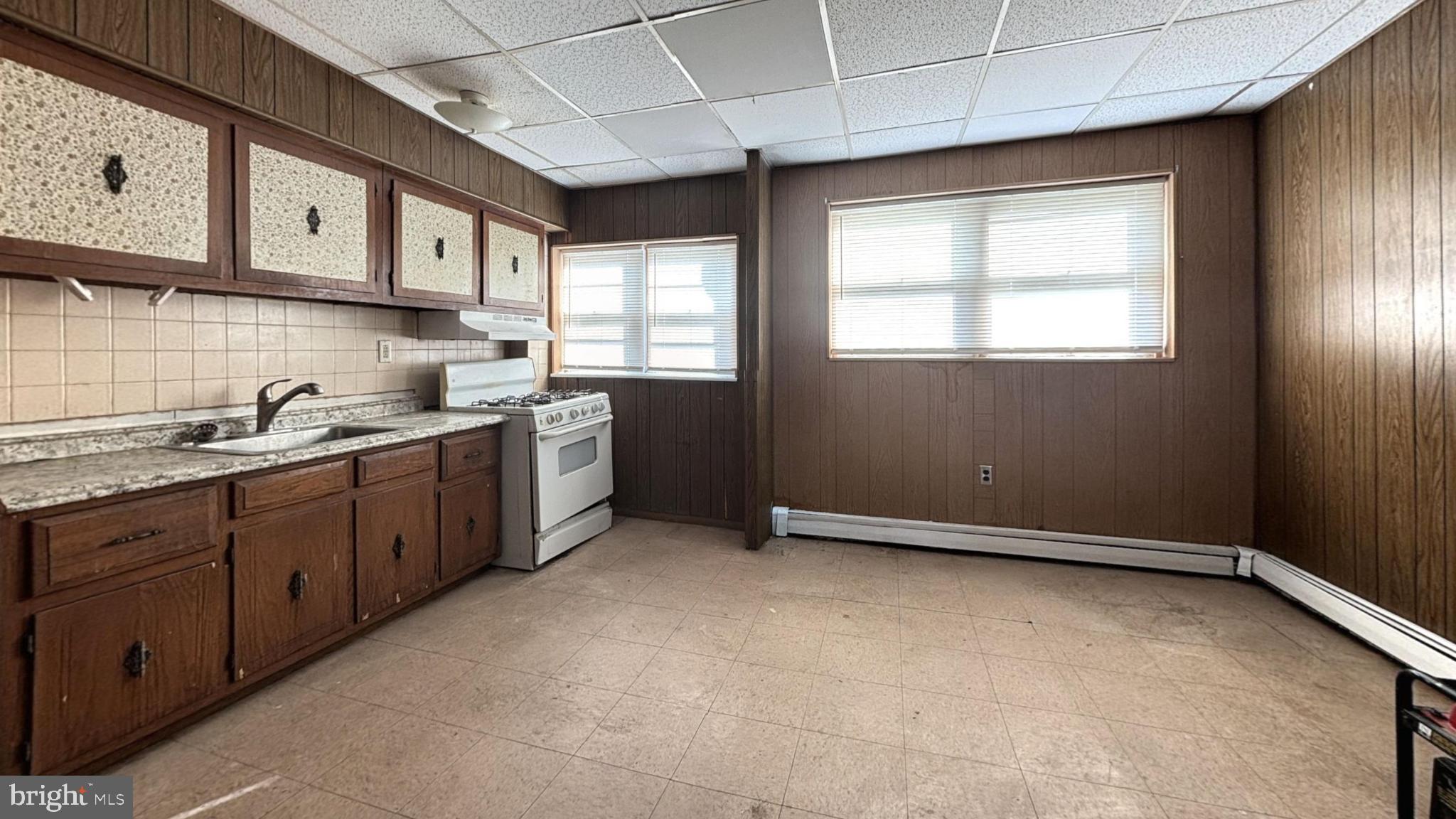 a kitchen with stainless steel appliances granite countertop a sink a stove and cabinets
