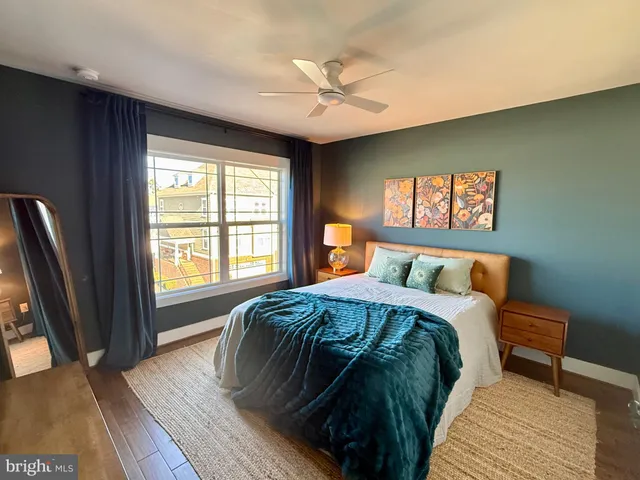 a bed sitting in a bedroom next to a window