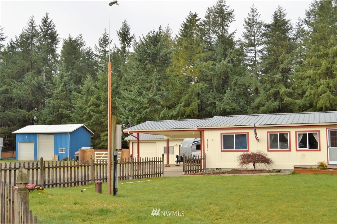 19129 Loganberry Street Southwest Rochester, WA 98579 - Photo 2 of 25 a view of a house with a yard and deck