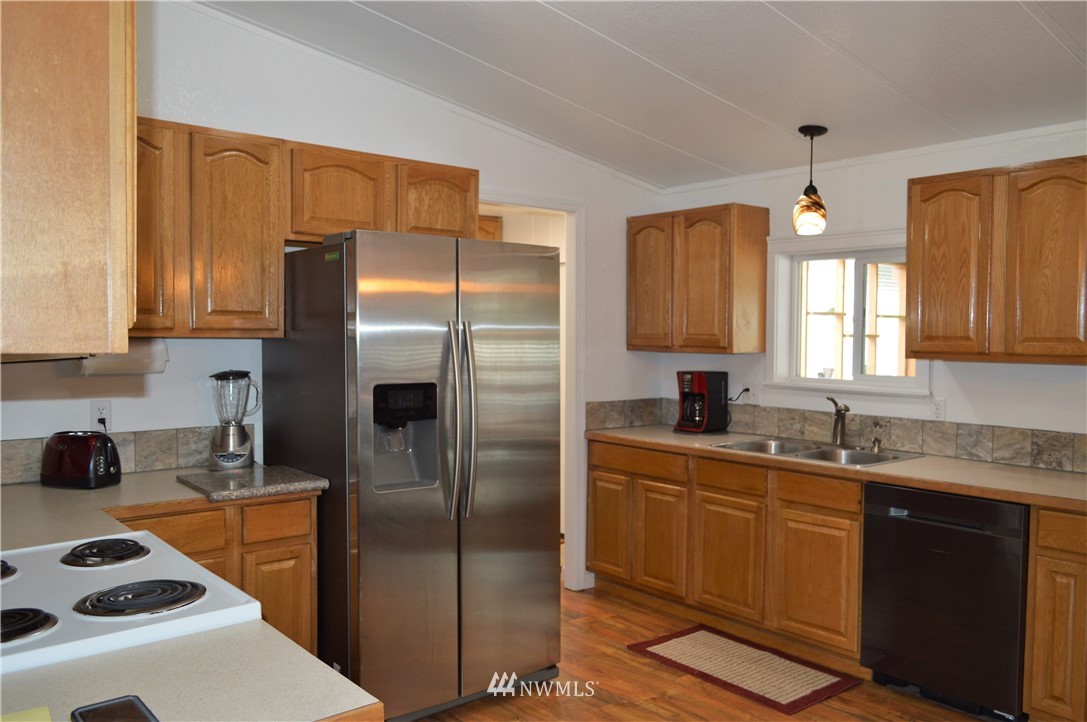 19129 Loganberry Street Southwest Rochester, WA 98579 - Photo 11 of 25 a kitchen with stainless steel appliances a refrigerator sink and microwave