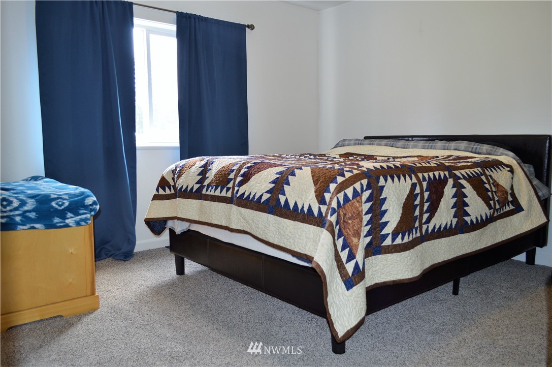 19129 Loganberry Street Southwest Rochester, WA 98579 - Photo 13 of 25 a bed sitting in a bedroom next to a window