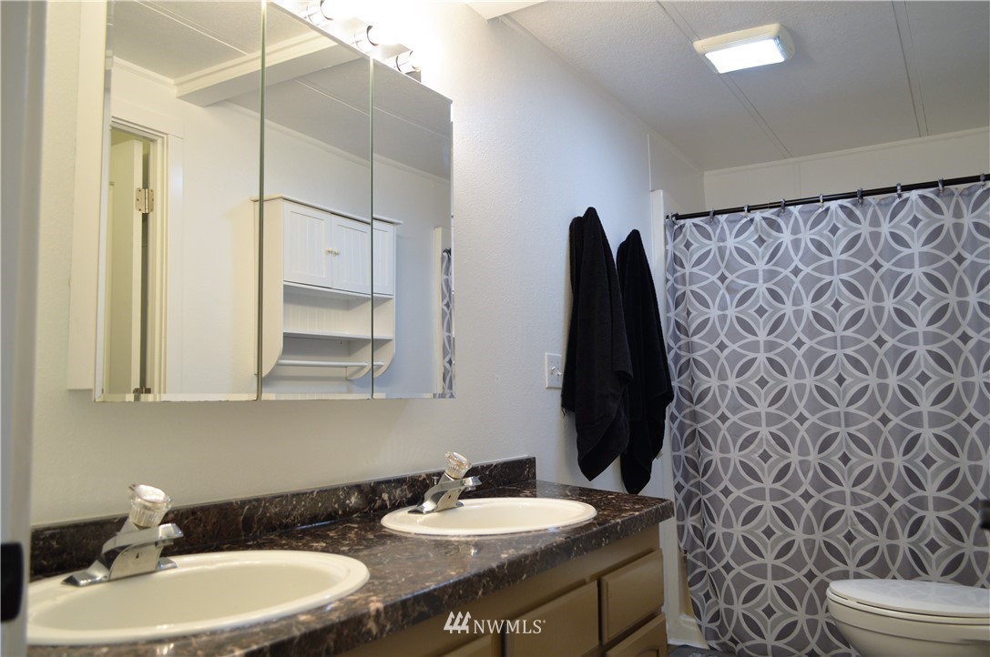 19129 Loganberry Street Southwest Rochester, WA 98579 - Photo 14 of 25 a bathroom with a sink and a mirror