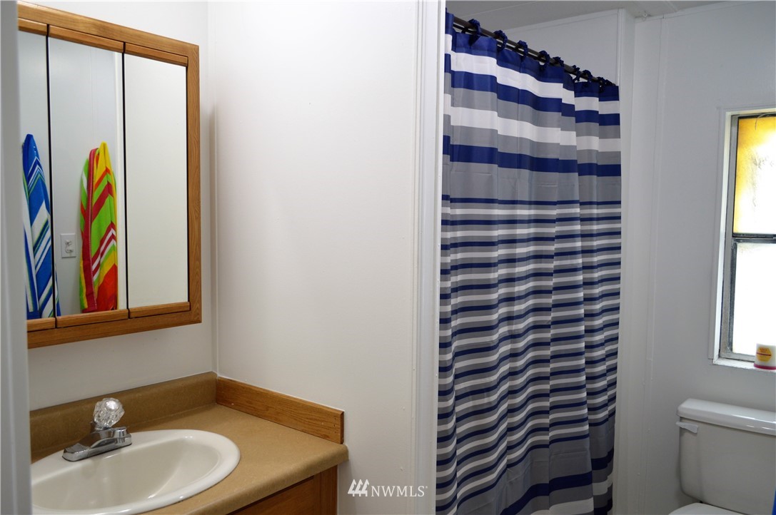 19129 Loganberry Street Southwest Rochester, WA 98579 - Photo 18 of 25 a bathroom with a sink and a mirror