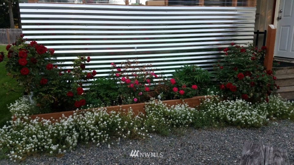 19129 Loganberry Street Southwest Rochester, WA 98579 - Photo 24 of 25 a view of a house with a flower garden in front of it