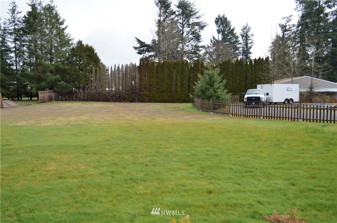 19129 Loganberry Street Southwest Rochester, WA 98579 - Photo 5 of 25 a view of a pool with a big yard and large trees