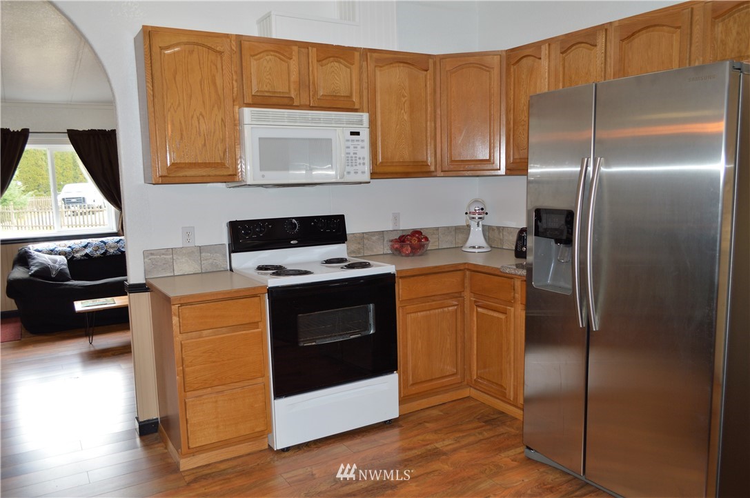 19129 Loganberry Street Southwest Rochester, WA 98579 - Photo 9 of 25 a kitchen with stainless steel appliances a stove a refrigerator and a microwave