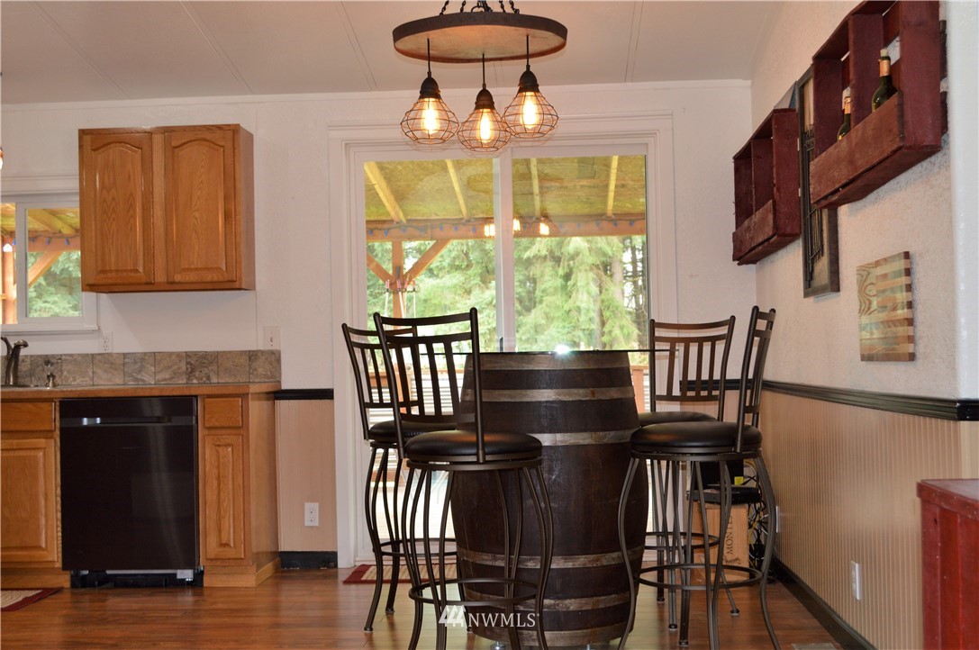 19129 Loganberry Street Southwest Rochester, WA 98579 - Photo 10 of 25 a view of a dining room with furniture window and wooden floor