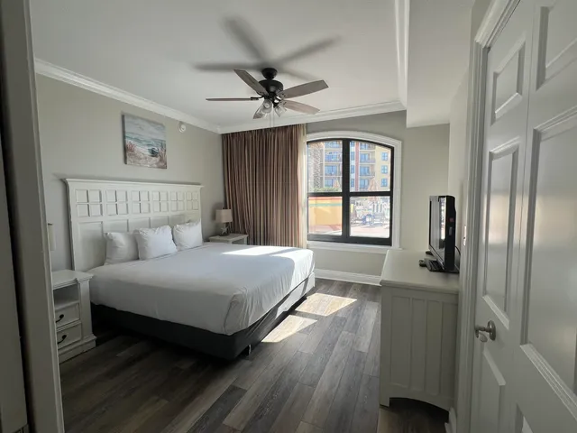 a bedroom with a bed next to a window