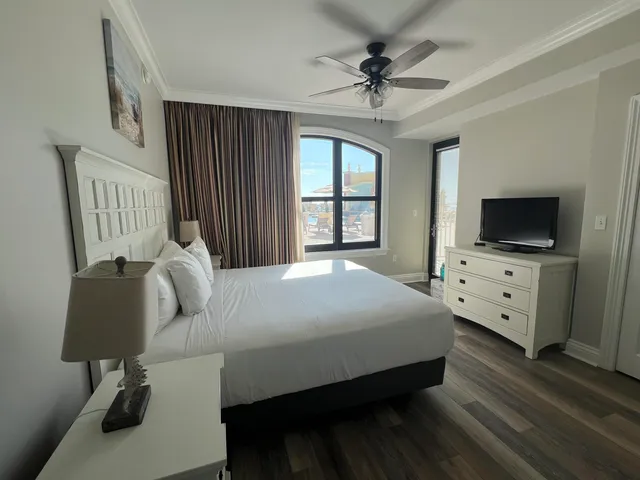 a bedroom with a bed and a flat screen tv