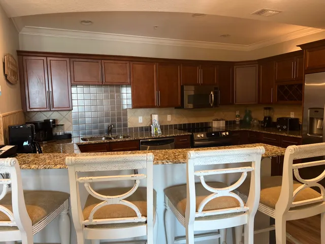 a kitchen with a stove a sink and a refrigerator