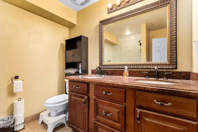 a spacious bedroom with a bed and a chandelier
