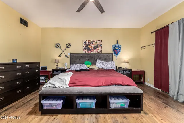 a bedroom with a bed and a flat screen tv