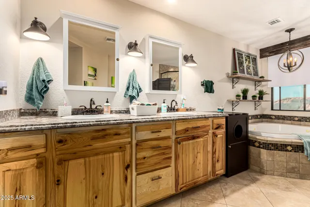 a bathroom with a tub a mirror and a shower