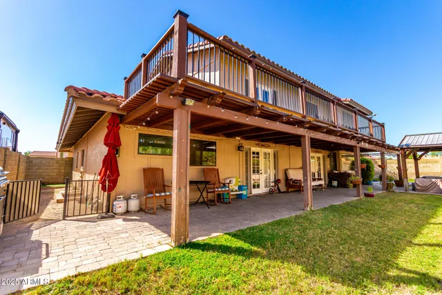 a view of a patio with a table and chairs under an umbrella