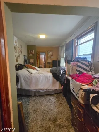 a living room with a couch and a dresser next to a window