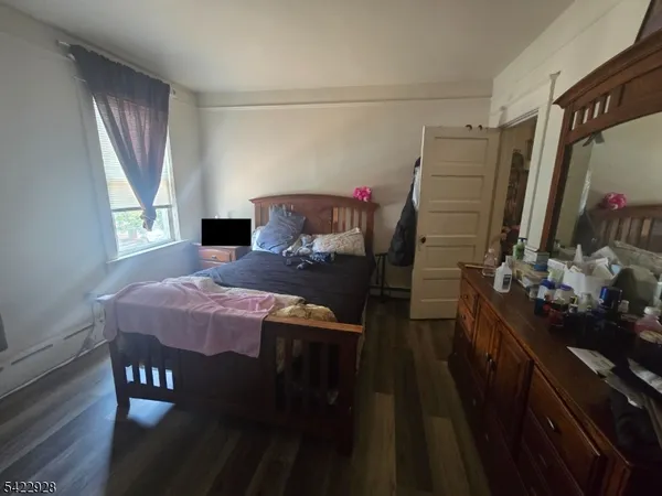 a bedroom with a bed and a mirror