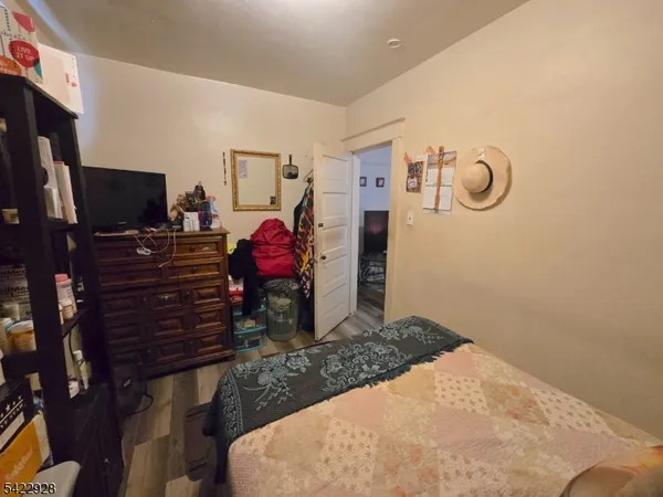 a bedroom with a bed and flat screen tv