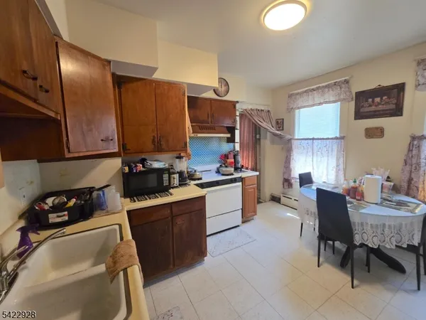 a kitchen with granite countertop sink cabinets and stainless steel appliances