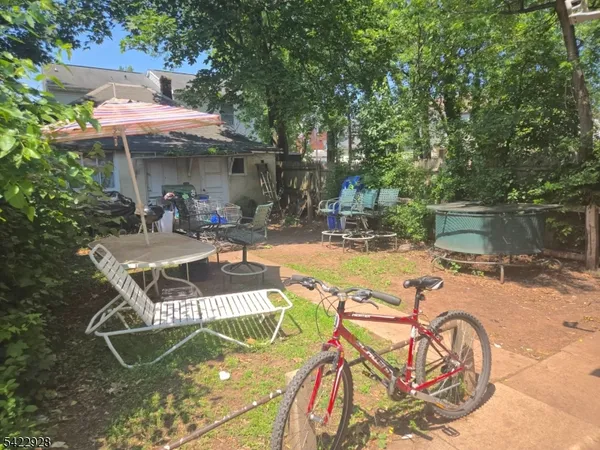 a view of a swimming pool with chairs and table in the patio
