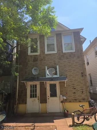 a front view of a house with chairs