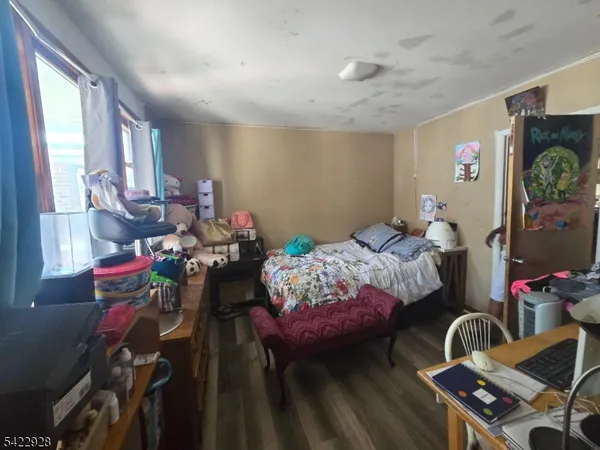 a bedroom with bed and a window