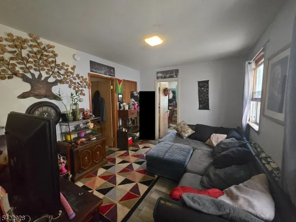 a living room with lots of furniture and clothes