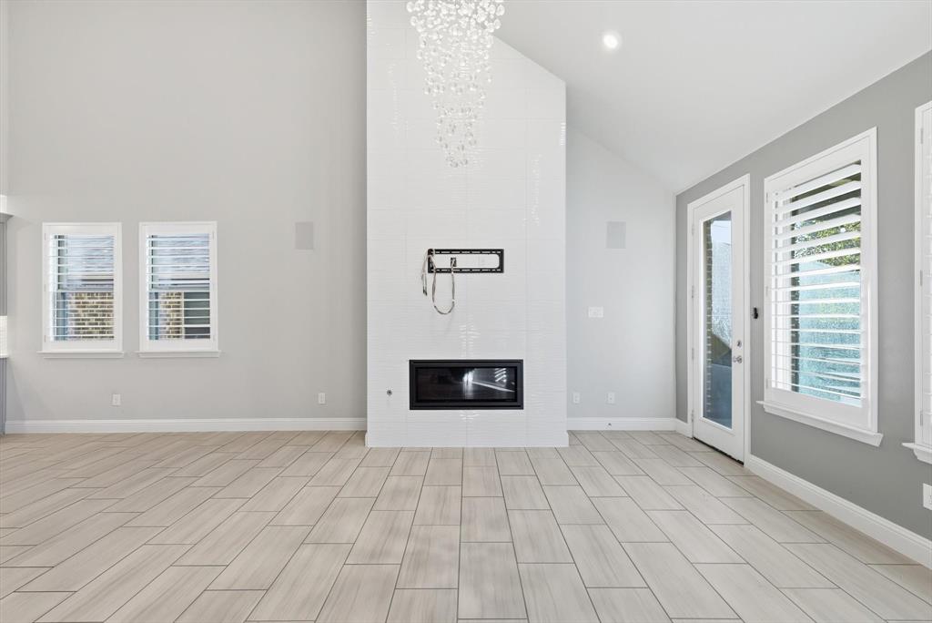 2114 Stanhill Drive Corinth, TX 76210 - Photo 12 of 40 an empty room with windows and fireplace