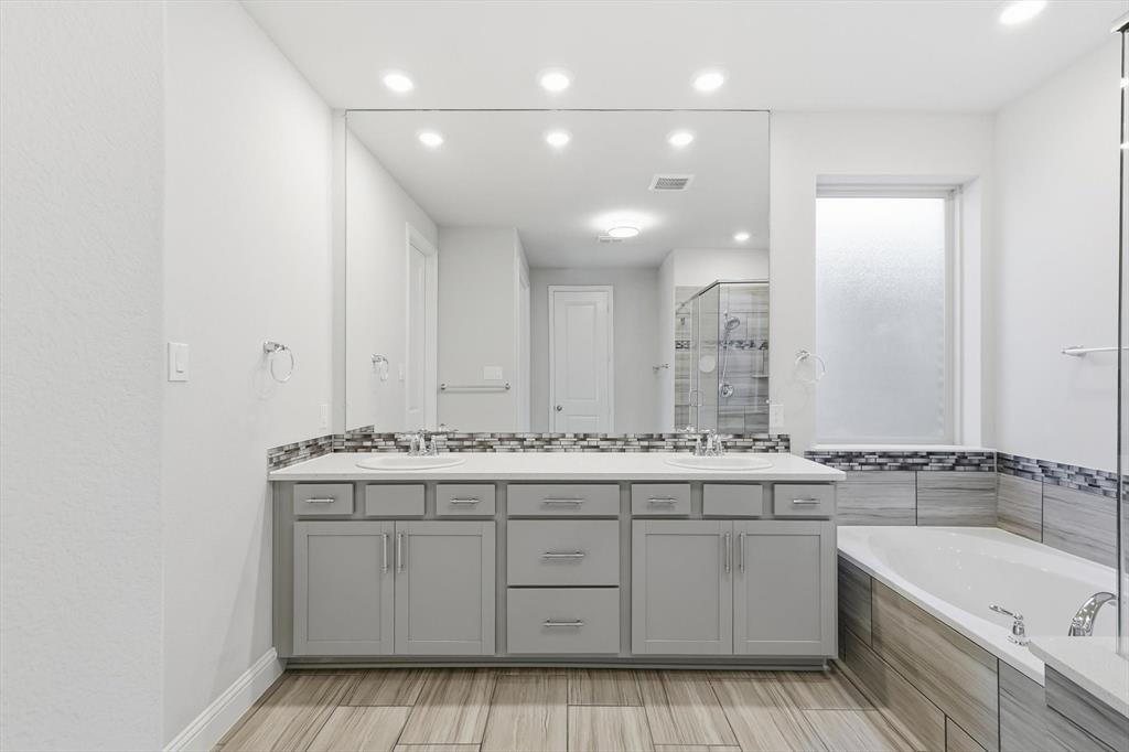 2114 Stanhill Drive Corinth, TX 76210 - Photo 19 of 40 a bathroom with a sink double vanity granite tub and mirror
