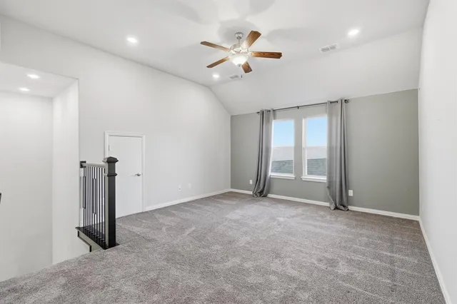 wooden floor in an empty room with a ceiling fan