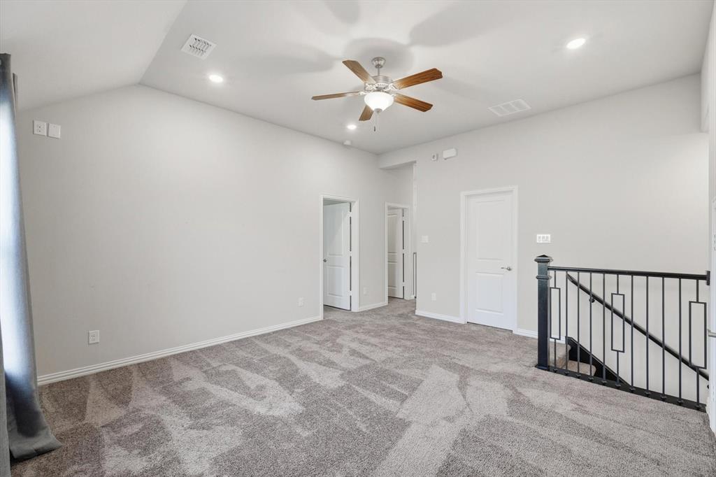 2114 Stanhill Drive Corinth, TX 76210 - Photo 25 of 40 a view of an empty room and chandelier fan
